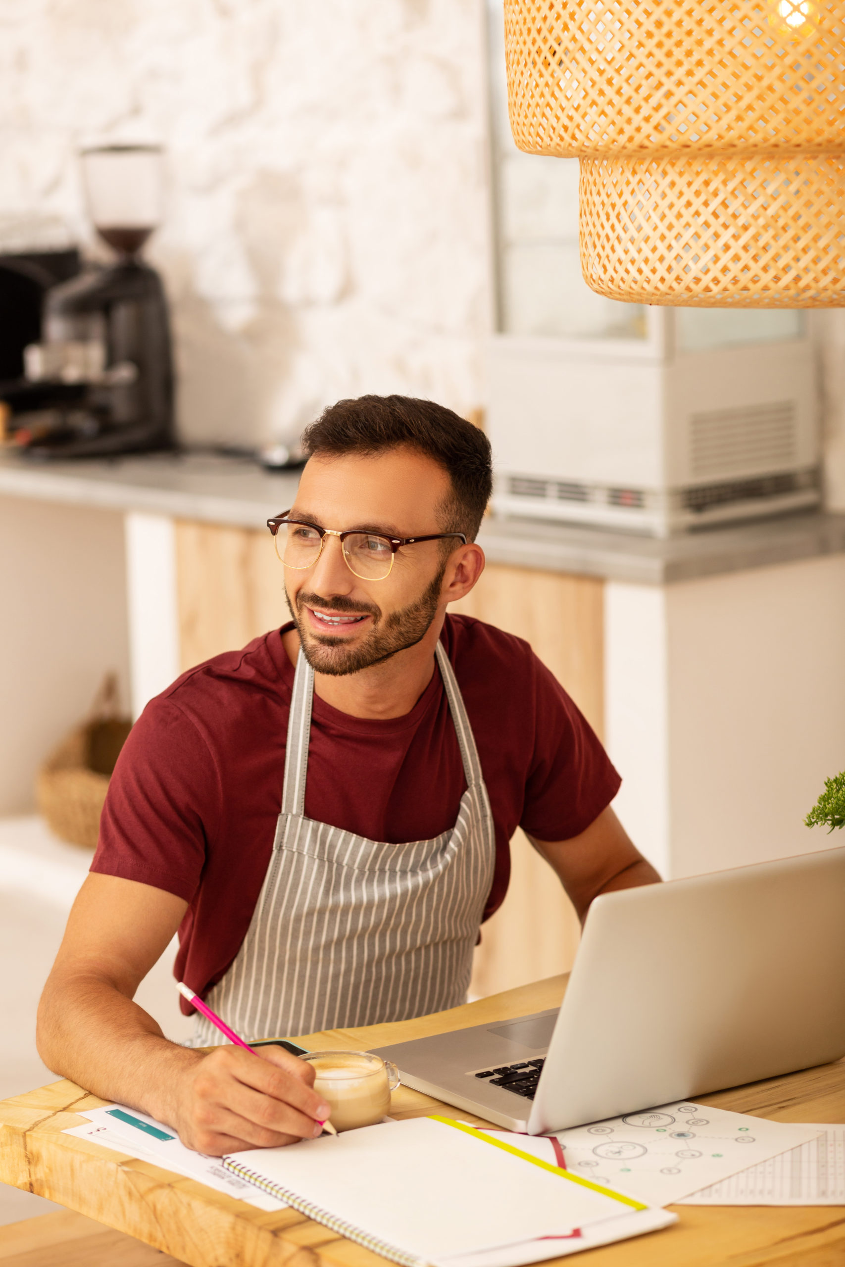 Top view of entrepreneur opening coffeehouse working hard sitting near laptop